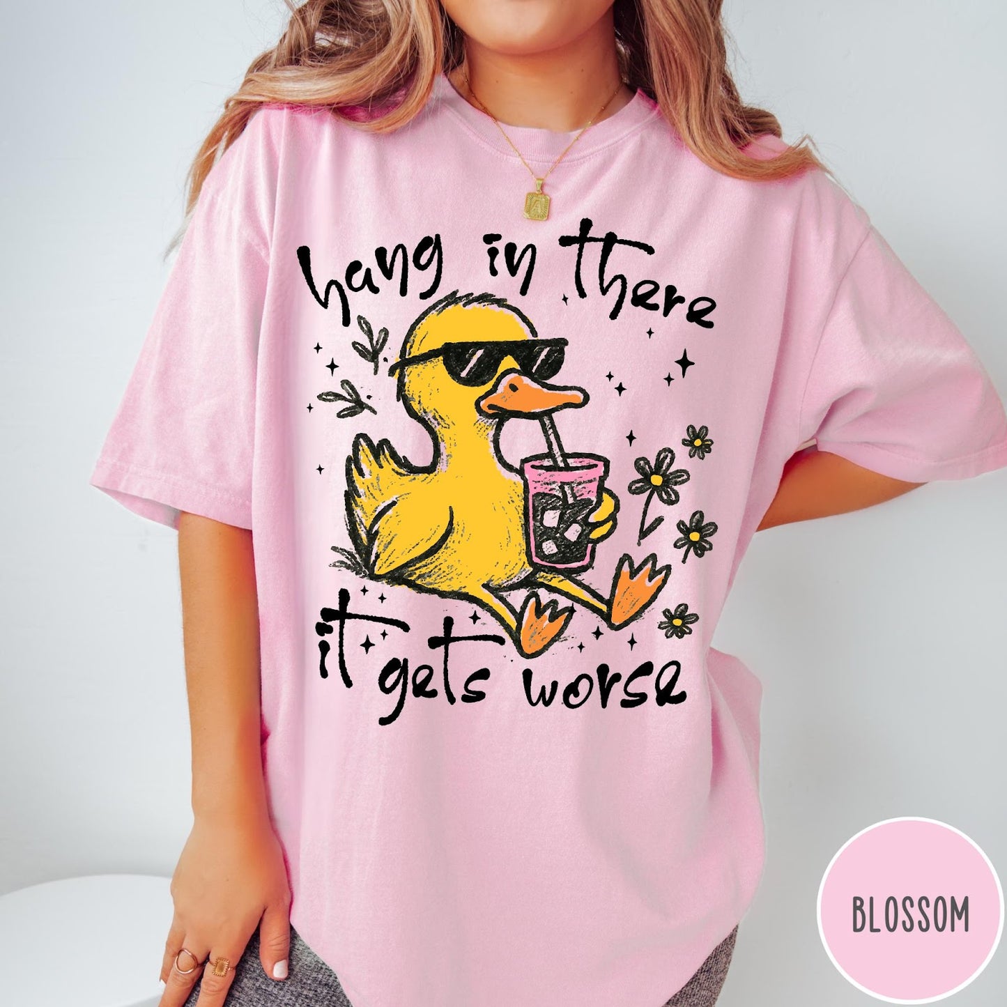 Comfort Colors tee in Blossom featuring illustrated duck wearing sunglasses and drinking iced coffee with floral accents