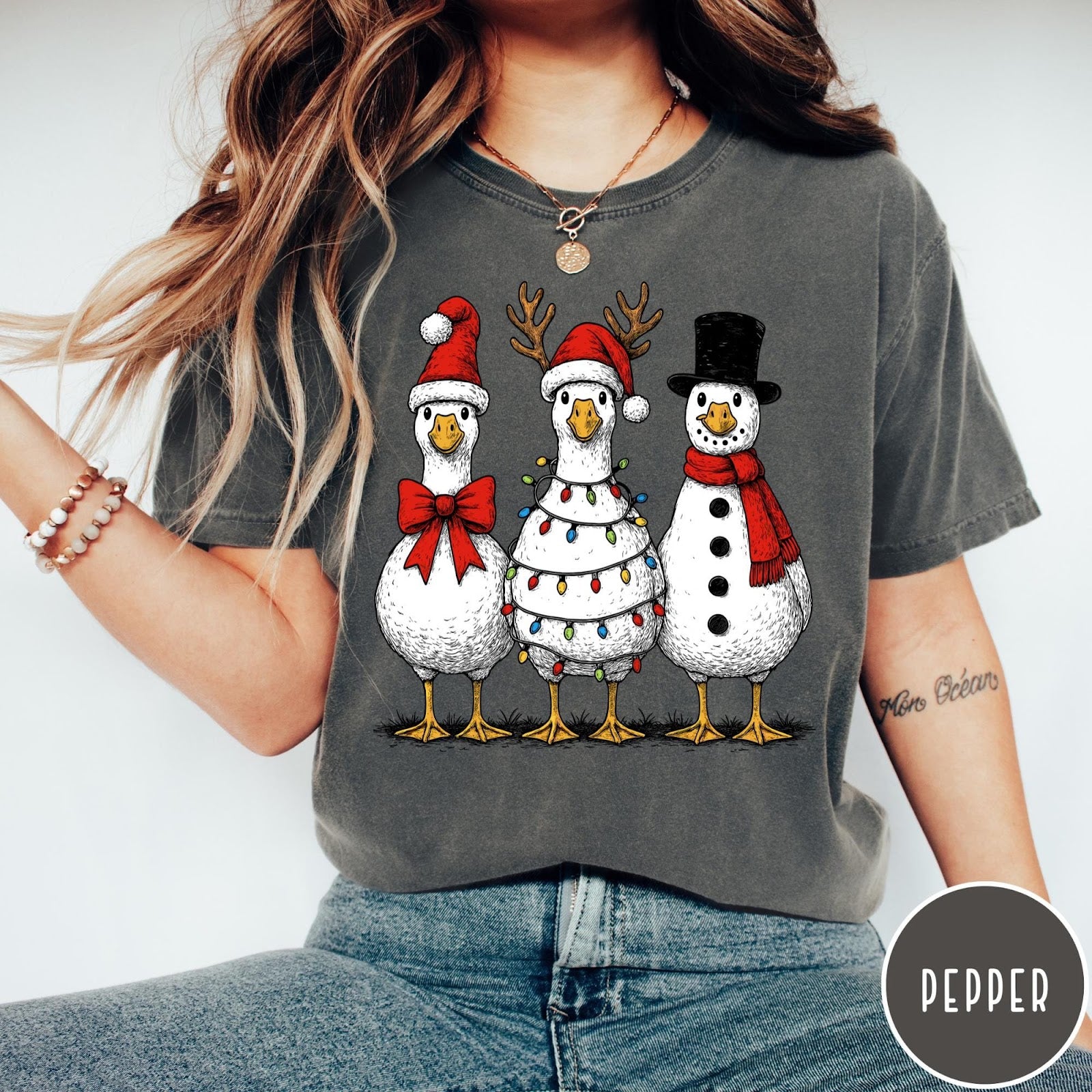 Comfort Colors tee in Pepper featuring festive holiday graphic of three geese dressed as Santa and snowman