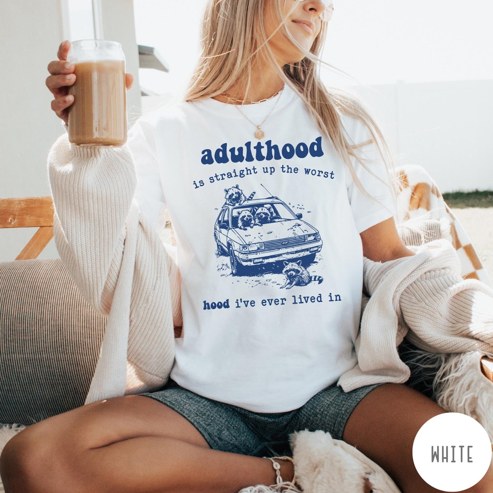 Comfort Colors tee in White featuring illustrated style graphic of raccoons sitting in and around a car