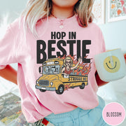 Comfort Colors tee in Blossom featuring retro style graphic of a woman waving from a burning school bus