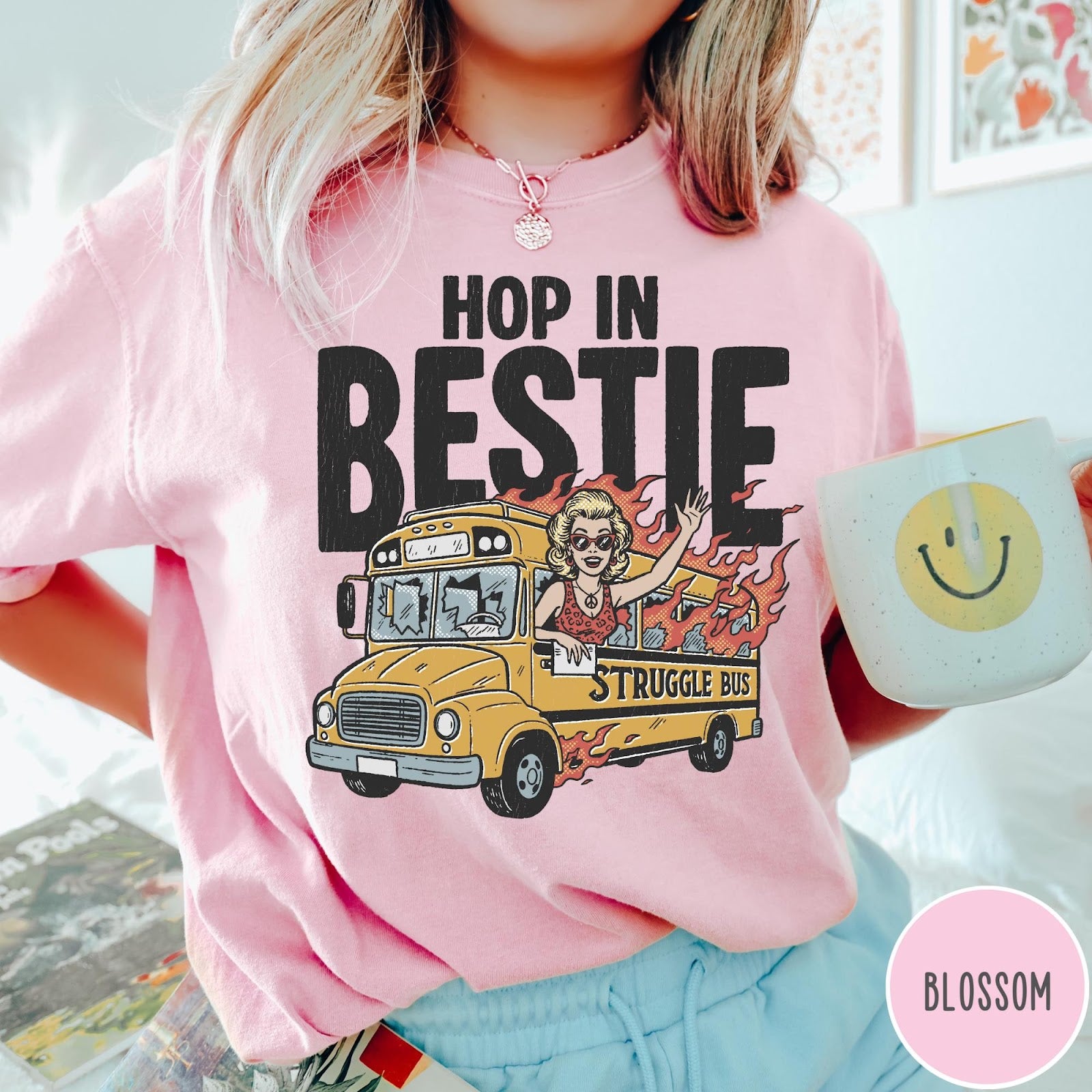 Comfort Colors tee in Blossom featuring retro style graphic of a woman waving from a burning school bus