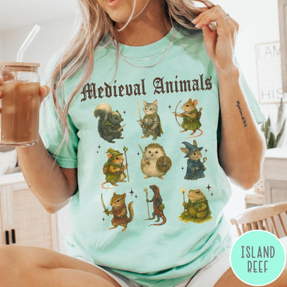 Comfort Colors tee in Island Reef featuring medieval animals graphic with fantasy characters including a cat, hedgehog, and frog