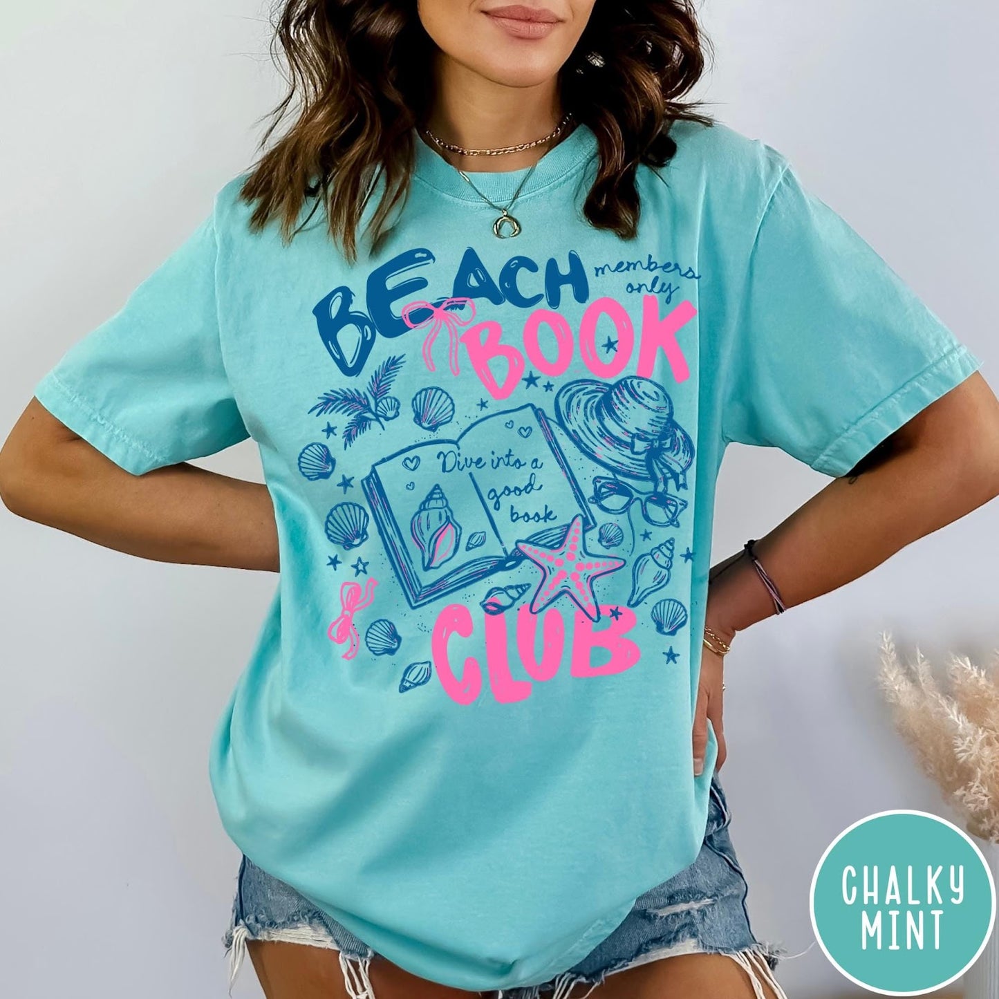 Comfort Colors tee in Chalky Mint featuring beach book club graphic with seashells, starfish, and a sun hat