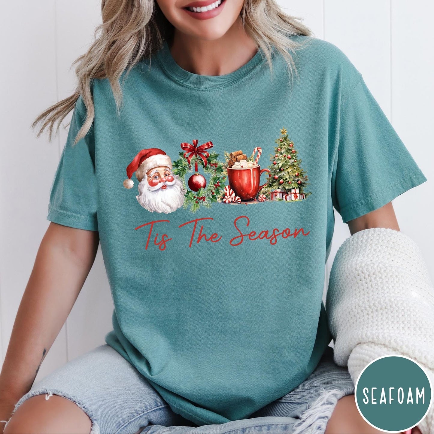 Comfort Colors tee in Seafoam featuring holiday design with Santa, wreath, hot cocoa, and Christmas tree graphic