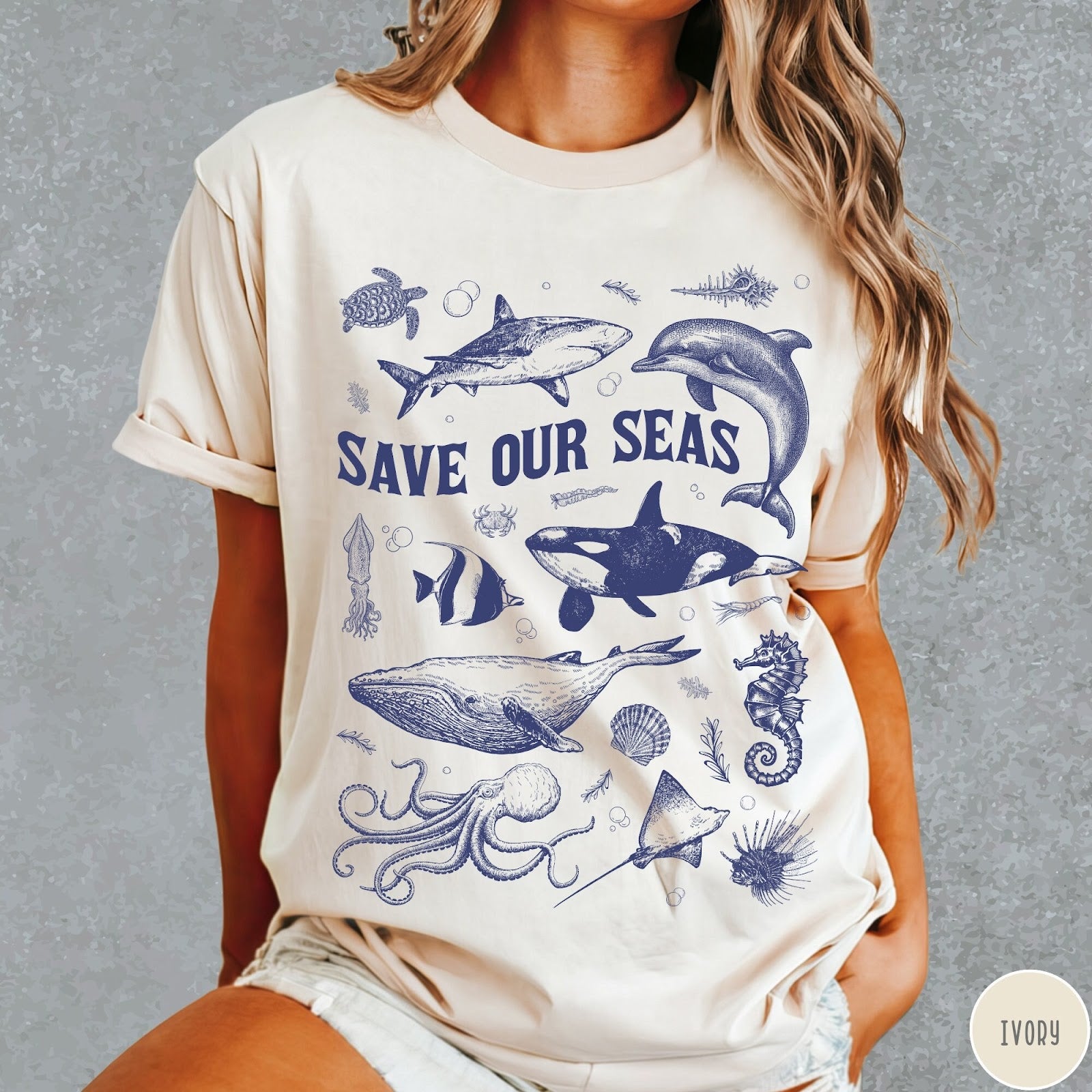 Comfort Colors tee in Ivory featuring marine life graphic design with various sea creatures and Save Our Seas text