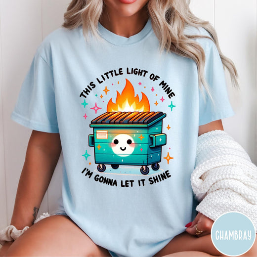 Comfort Colors tee in Chambray featuring cartoon style graphic of a smiling dumpster fire with text