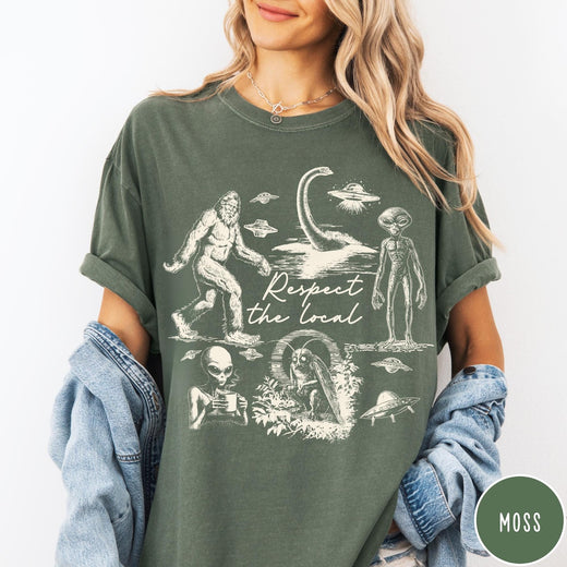 Comfort Colors tee in Moss featuring vintage style graphic of Bigfoot, Loch Ness Monster, aliens, and UFOs
