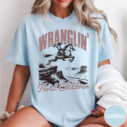 Comfort Colors tee in Chambray featuring western style graphic of a cowboy on horseback jumping a canyon
