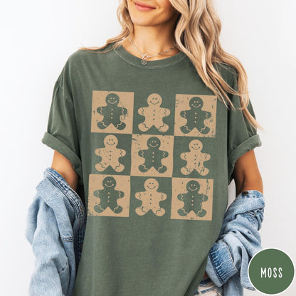 Comfort Colors tee in Moss featuring a grid design with nine distressed gingerbread man cookie graphic illustrations