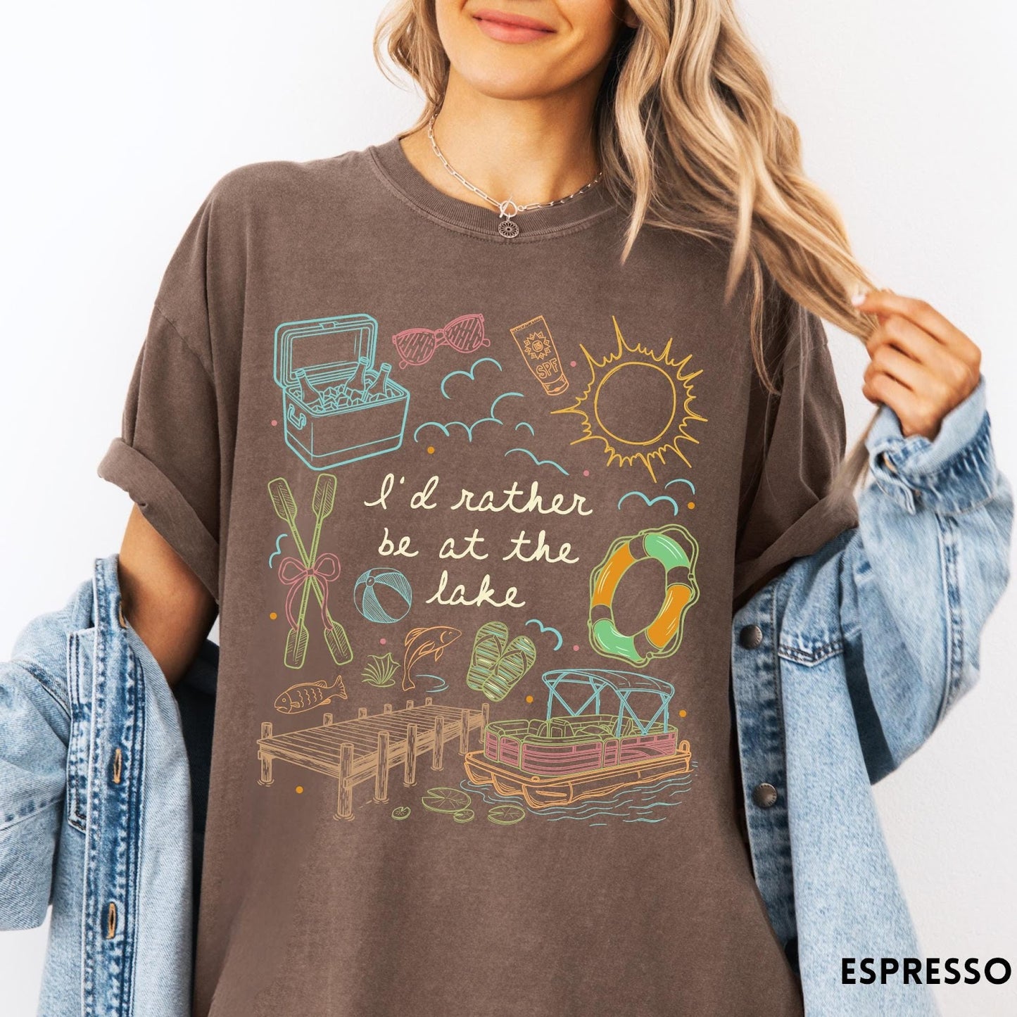 Comfort Colors tee in Espresso featuring lake vacation graphic with pontoon boat, dock, and summer accessories