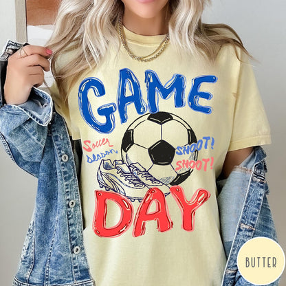 Comfort Colors tee in Butter featuring soccer graphic with ball, cleats, and Game Day typography design