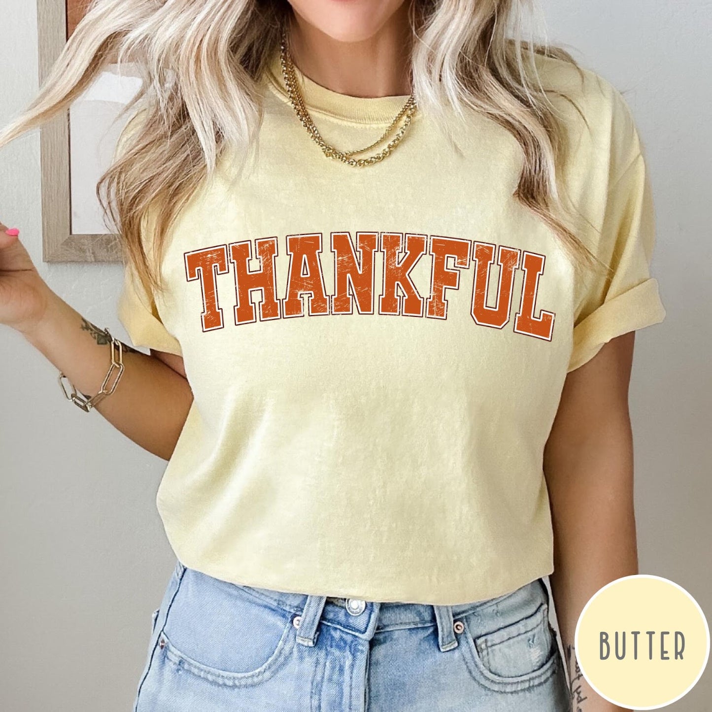 Comfort Colors tee in Butter featuring typography graphic with the word Thankful in an arched varsity style