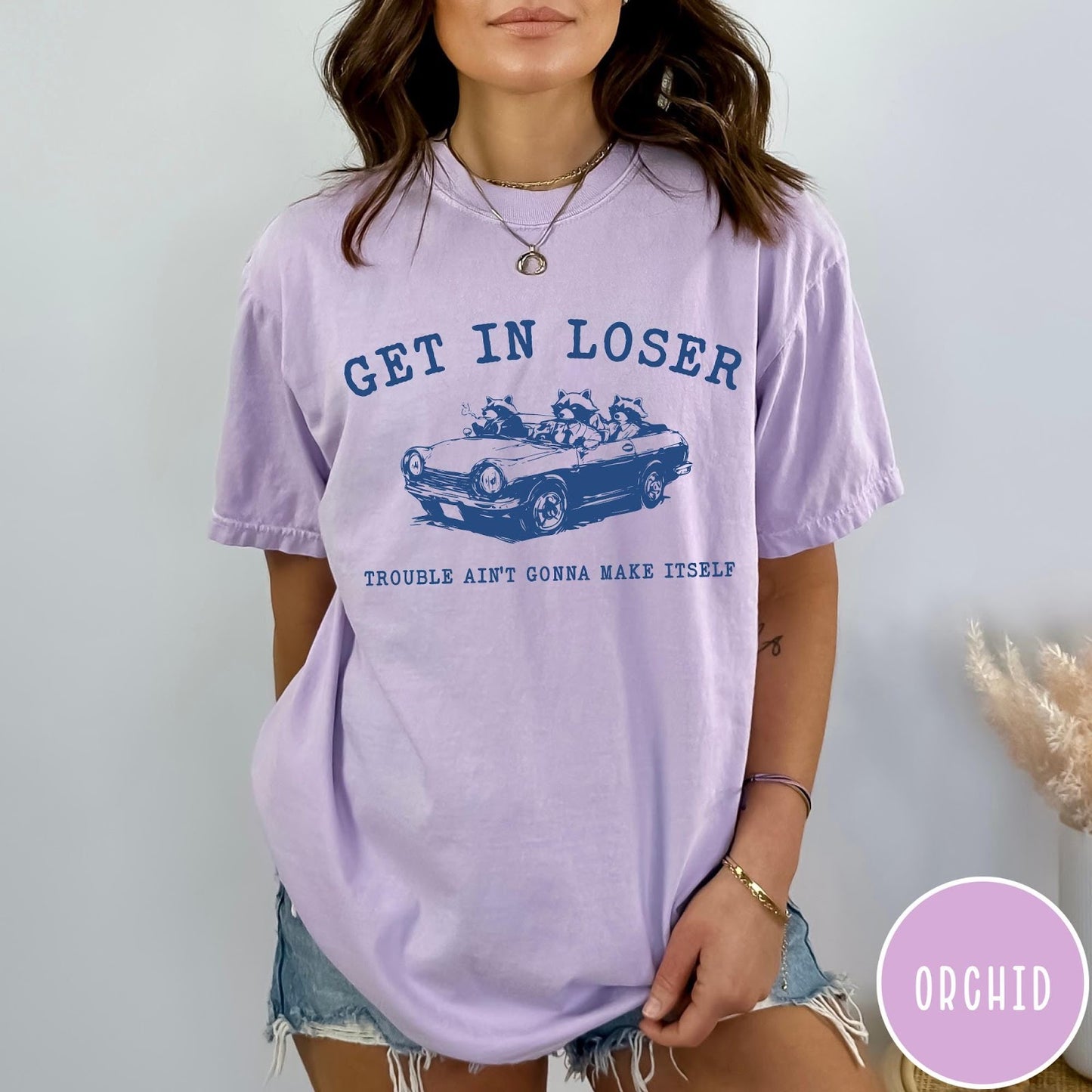 Comfort Colors tee in Orchid featuring vintage style graphic of three raccoons driving a convertible car