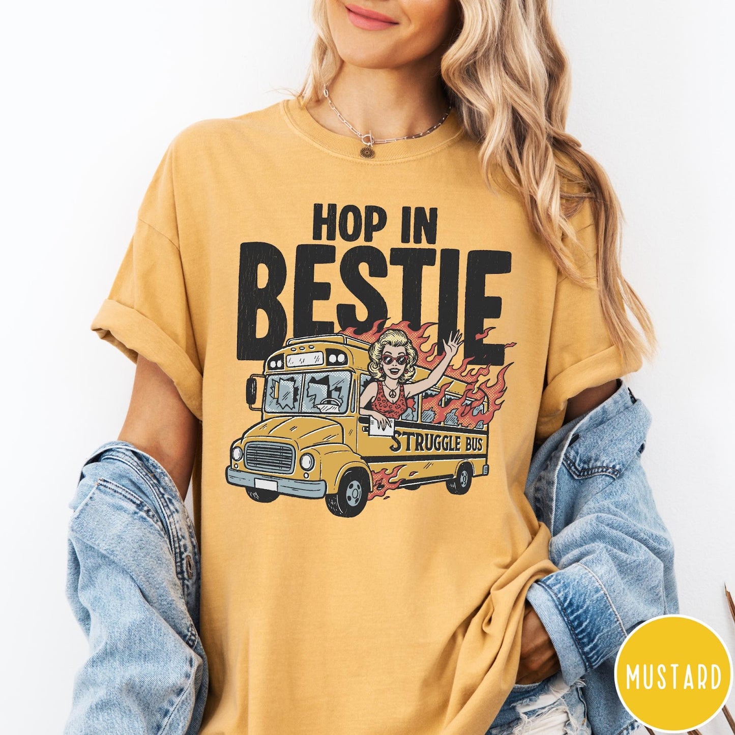 Comfort Colors tee in Mustard featuring retro cartoon style graphic of a woman driving a burning bus
