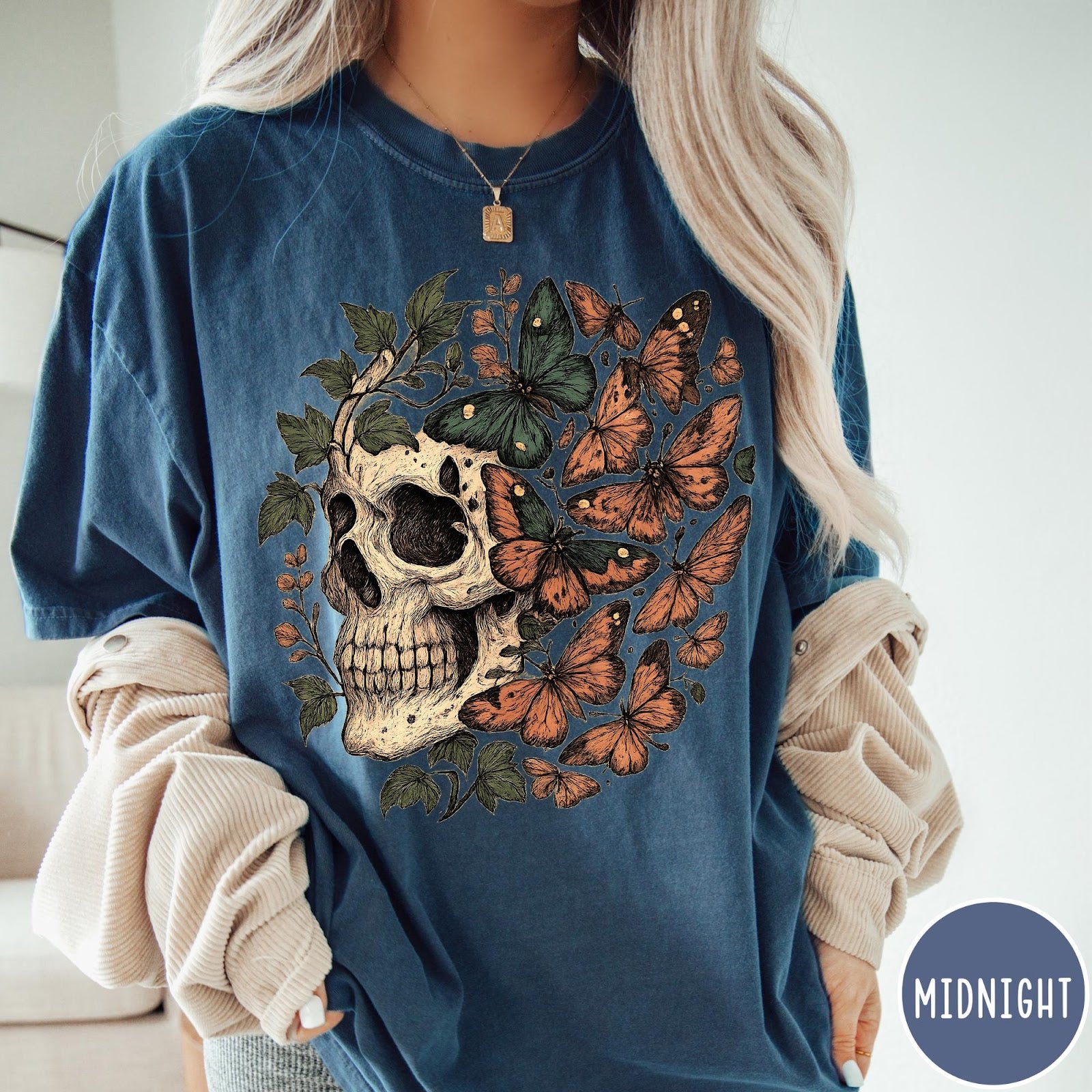 Comfort Colors tee in Midnight featuring vintage style graphic with a skull surrounded by various colorful butterflies