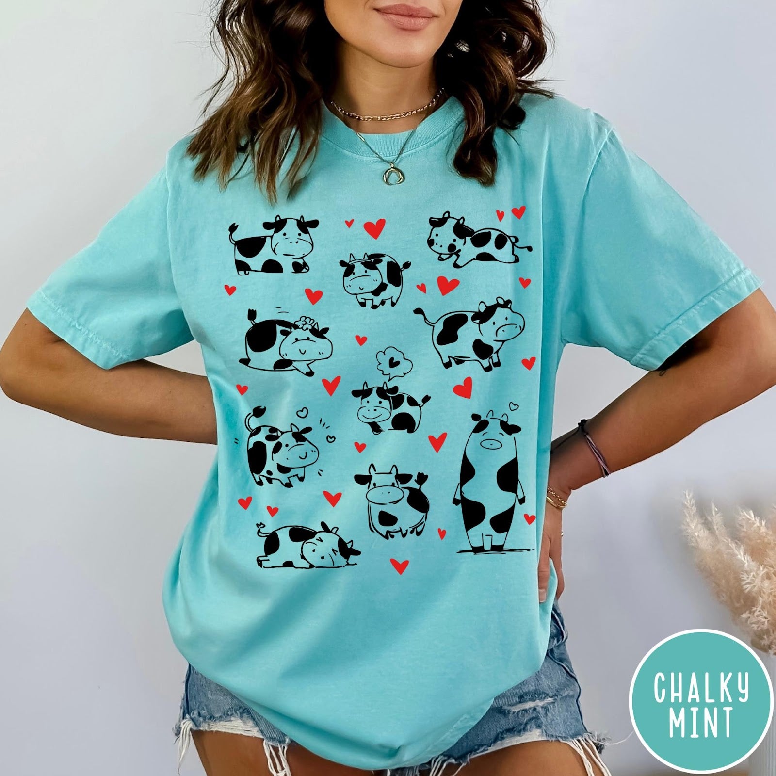 Comfort Colors tee in Chalky Mint featuring cute cow lover graphic with various black and white cow illustrations