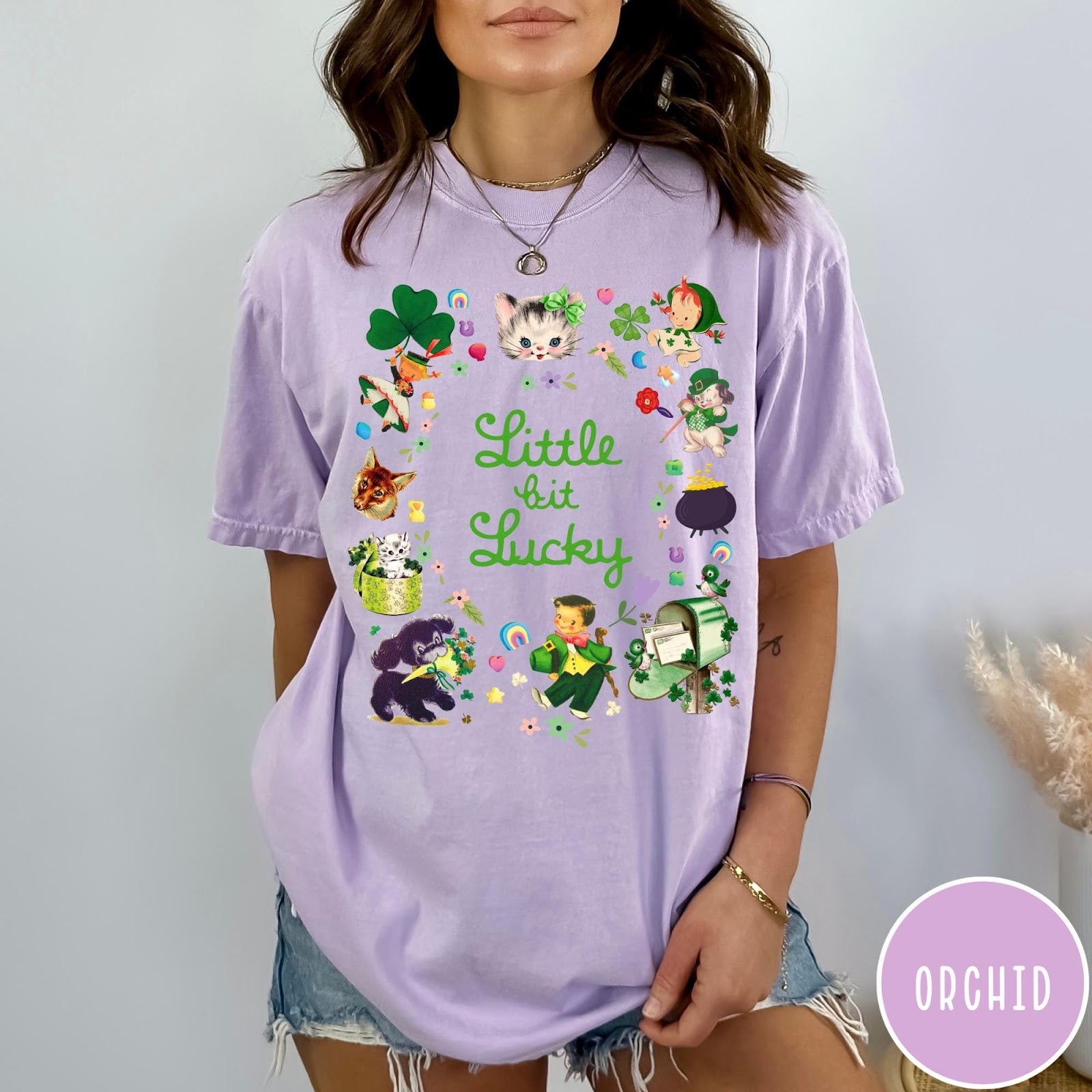 Comfort Colors tee in Orchid featuring St. Patrick's Day collage with kittens, leprechauns, and festive holiday icons