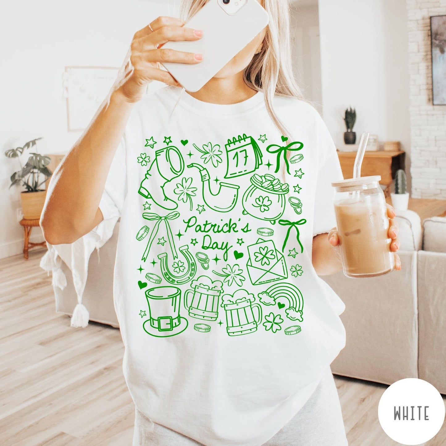 Comfort Colors tee in White featuring line art style St. Patrick's Day icons including shamrocks and leprechaun hat