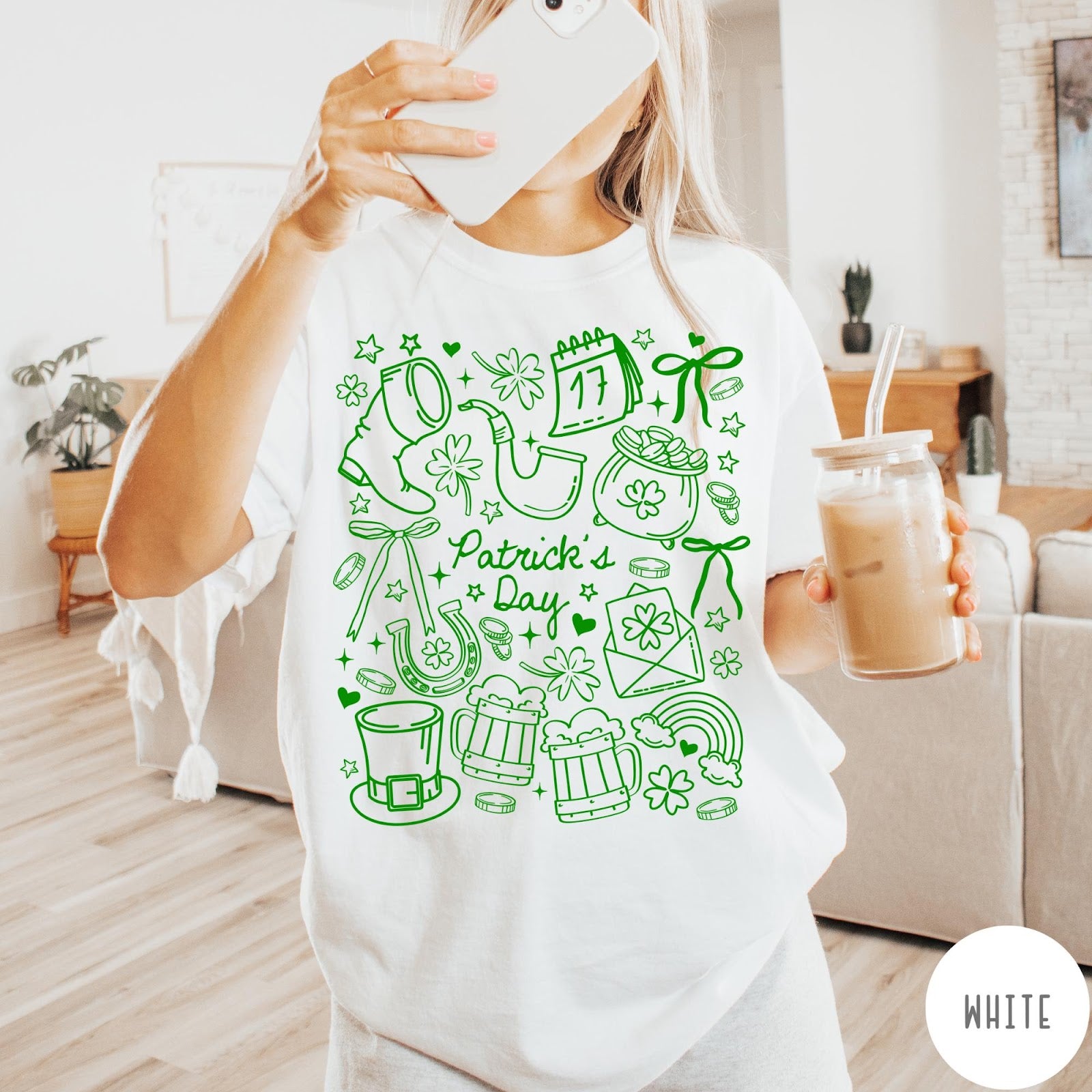 Comfort Colors tee in White featuring line art style St. Patrick's Day icons including shamrocks and leprechaun hat
