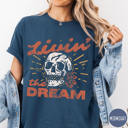 Comfort Colors tee in Midnight featuring vintage style skull graphic with Livin the Dream text design