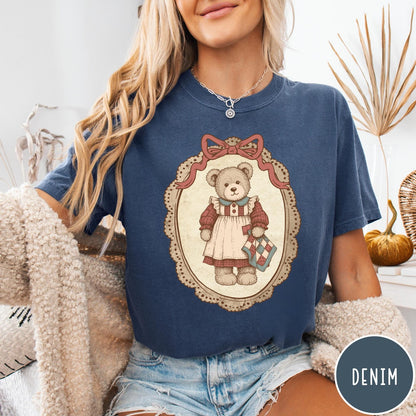 Comfort Colors tee in Denim featuring vintage style teddy bear graphic inside a decorative lace oval frame