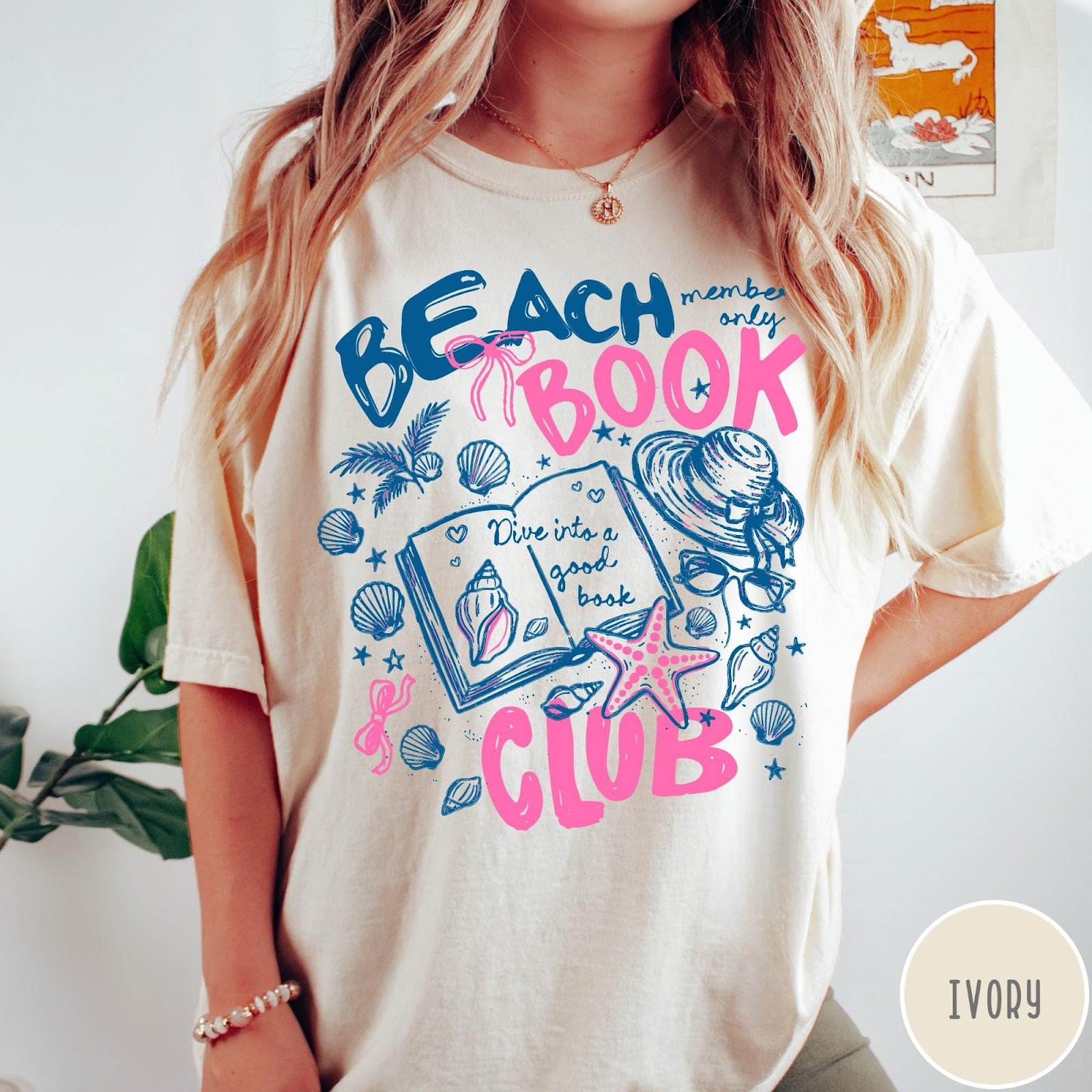 Comfort Colors tee in Ivory featuring beach book club graphic with seashells, starfish, and a sun hat