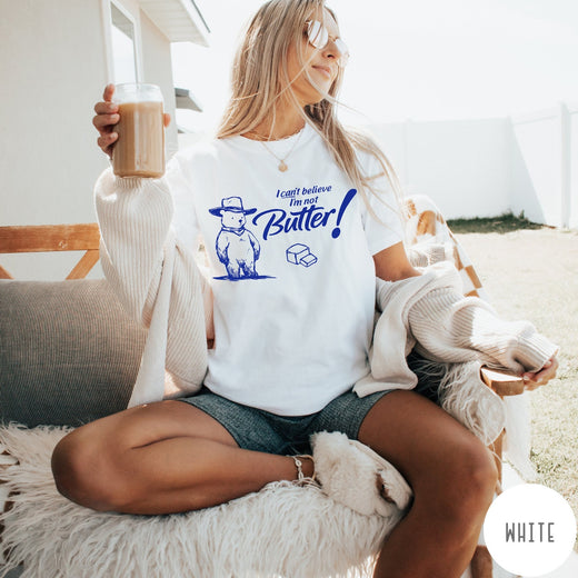 Comfort Colors tee in White featuring bear graphic with cowboy hat and text I can't believe I'm not Butter