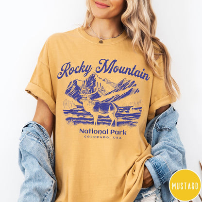 Comfort Colors tee in Mustard featuring vintage style graphic of an elk standing in front of mountains
