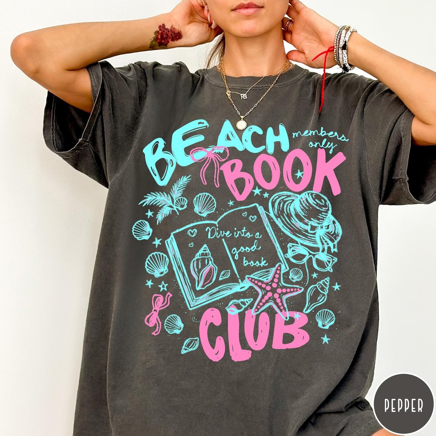 Comfort Colors tee in Pepper featuring beach book club graphic with seashells, starfish, and a sun hat