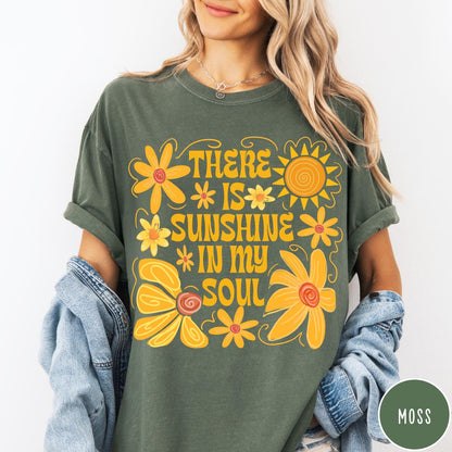 Comfort Colors tee in Moss featuring inspirational quote design with yellow flowers and a sun graphic