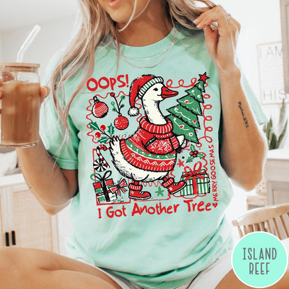 Comfort Colors tee in Island Reef featuring festive goose graphic wearing a Santa hat and Christmas sweater holding tree