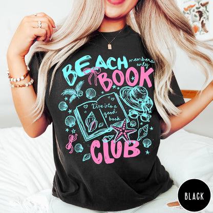 Comfort Colors tee in Black featuring beach book club graphic with open book, shells, and hat