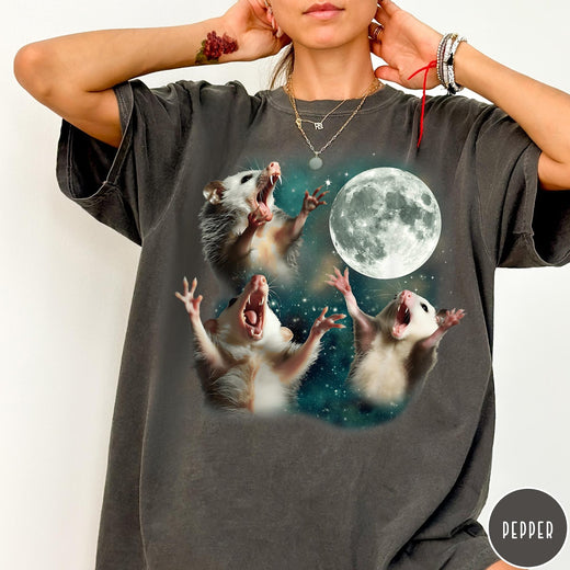Comfort Colors tee in Pepper featuring vintage graphic style with three screaming possums reaching for the moon