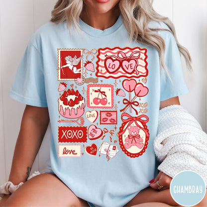 Comfort Colors tee in Chambray featuring Valentine collage graphic with cupid, teddy bear, hearts, and sweet treats