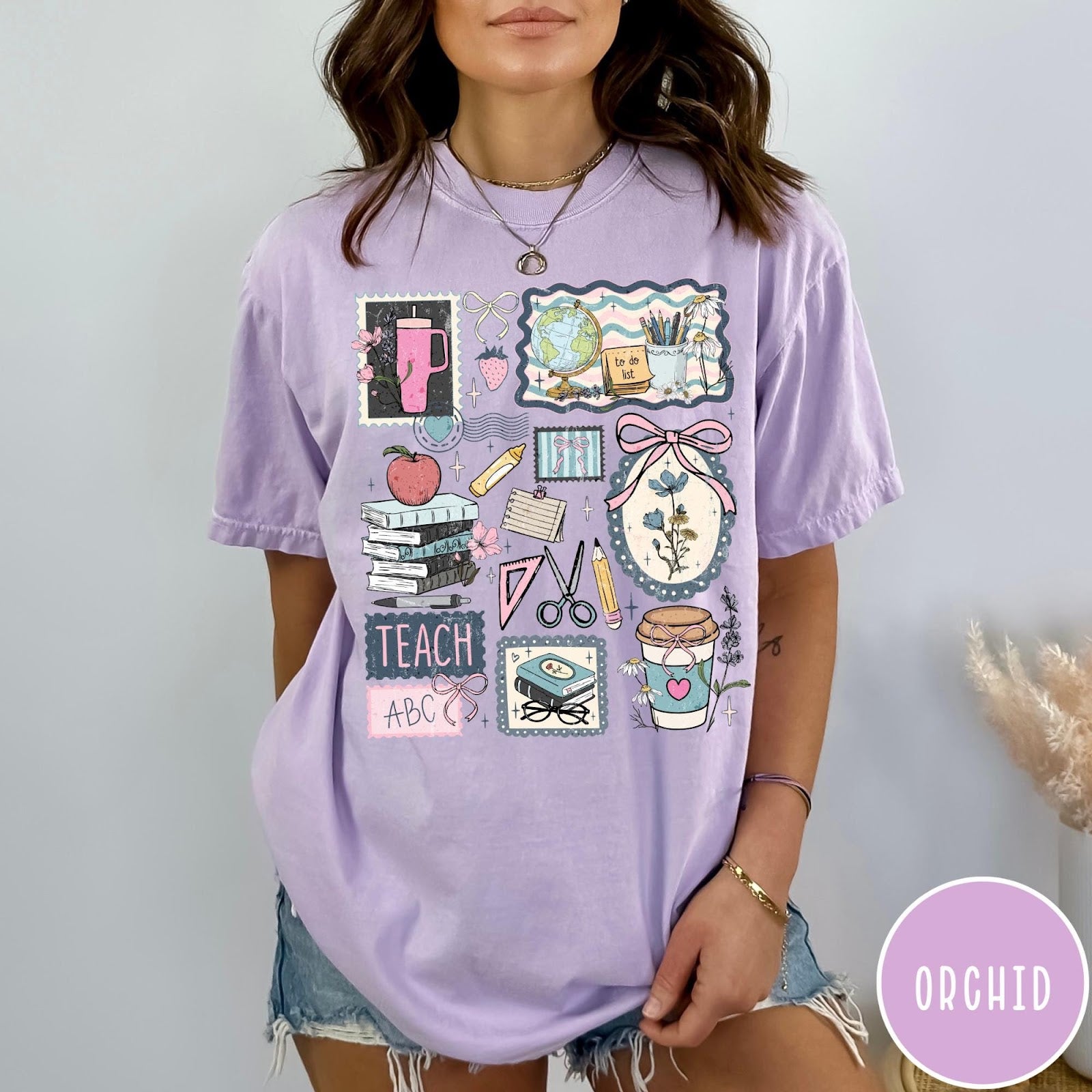 Comfort Colors tee in Orchid featuring collage style graphic with school supplies and teacher life themed illustrations