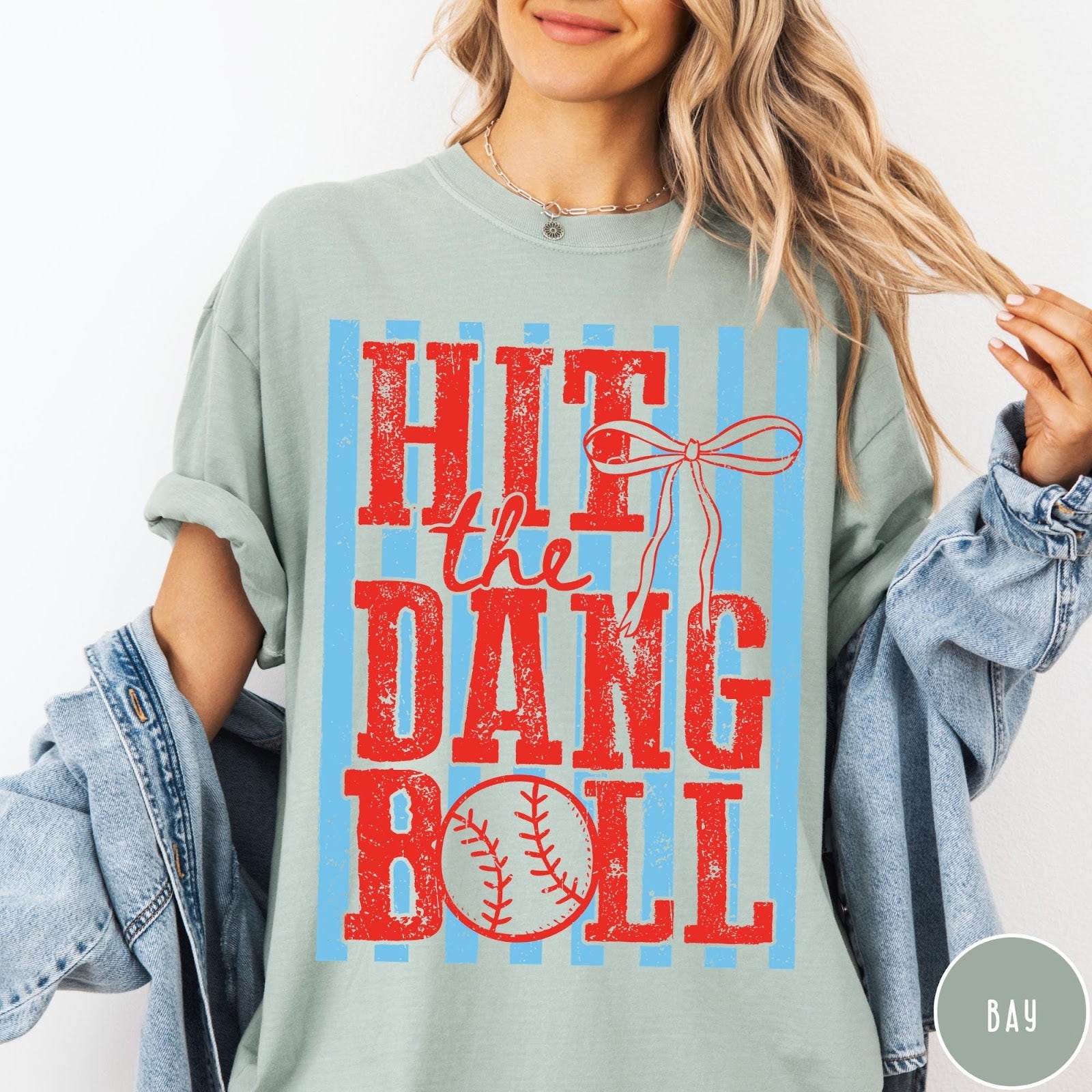 Comfort Colors tee in Bay featuring baseball graphic with red text and blue stripes and a bow