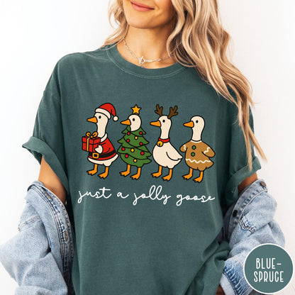 Comfort Colors tee in Blue Spruce featuring festive geese dressed as Santa, Christmas tree, reindeer, and gingerbread