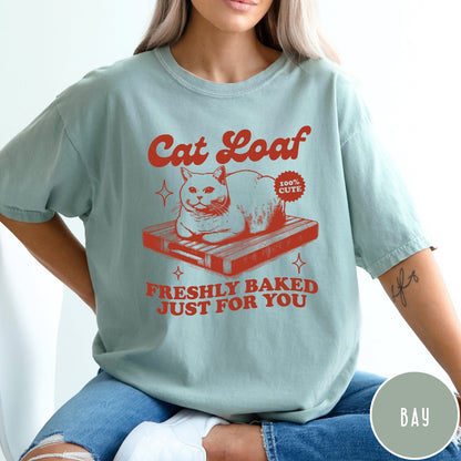 Comfort Colors tee in Bay featuring graphic style cat loaf sitting on a wooden cutting board