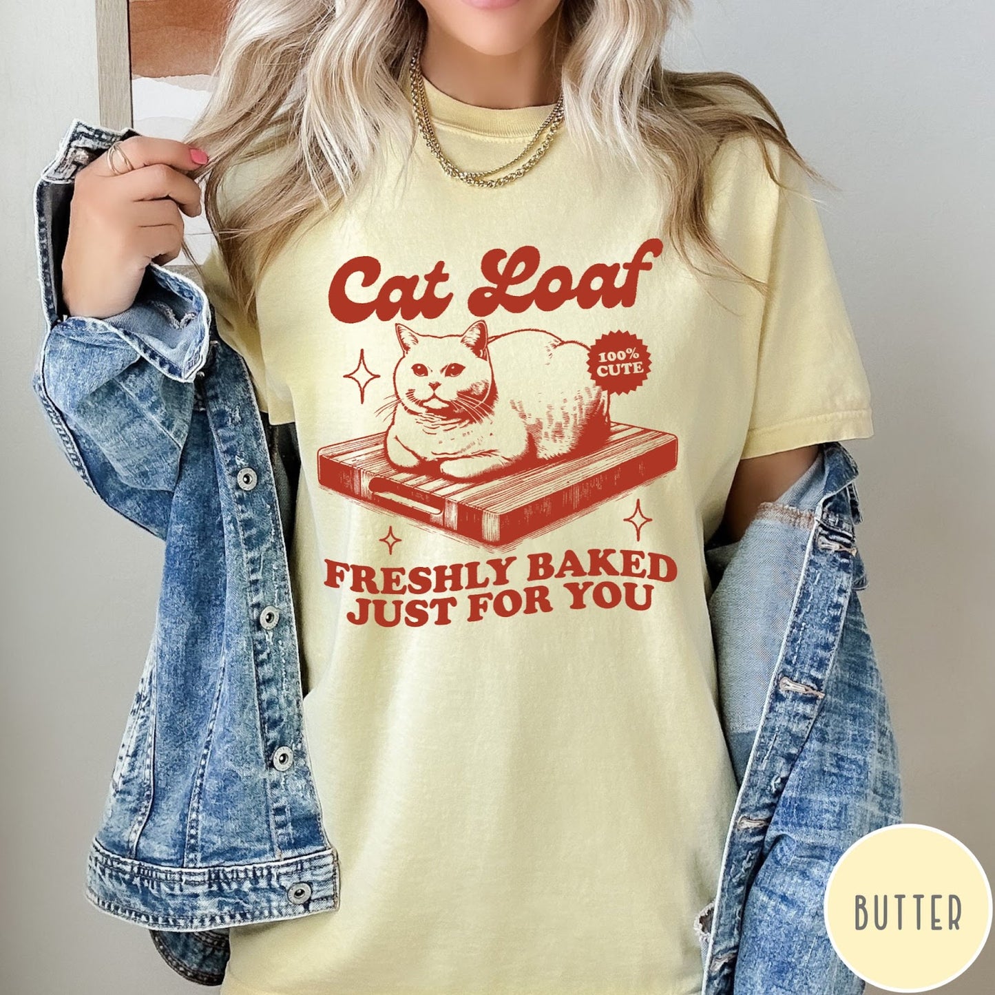Comfort Colors tee in Butter featuring graphic style cat loaf sitting on a wooden cutting board