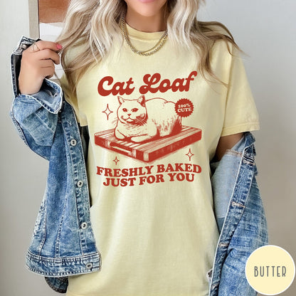Comfort Colors tee in Butter featuring graphic style cat loaf sitting on a wooden cutting board