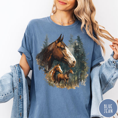 Comfort Colors tee in Blue Jean featuring vintage style graphic of three horses standing in a pine forest