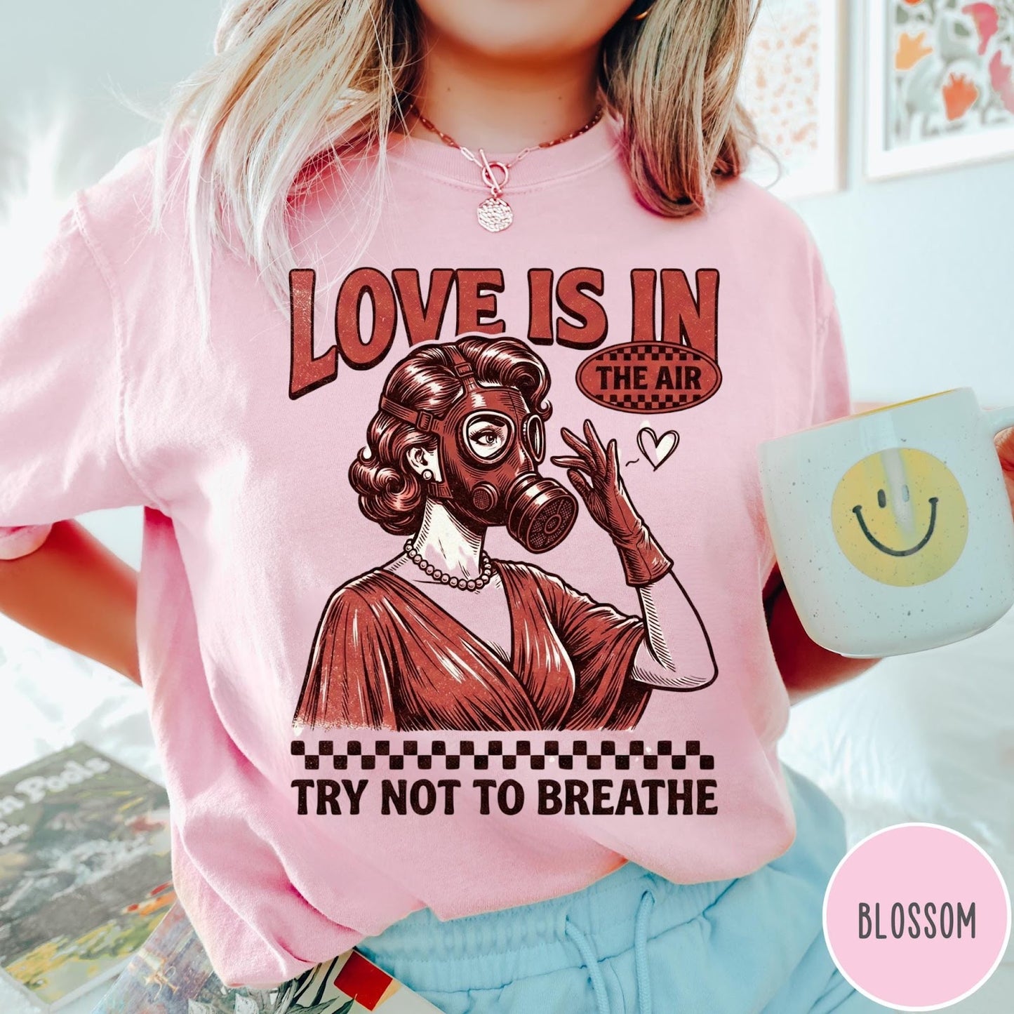 Comfort Colors tee in Blossom featuring retro style graphic of a woman wearing a gas mask