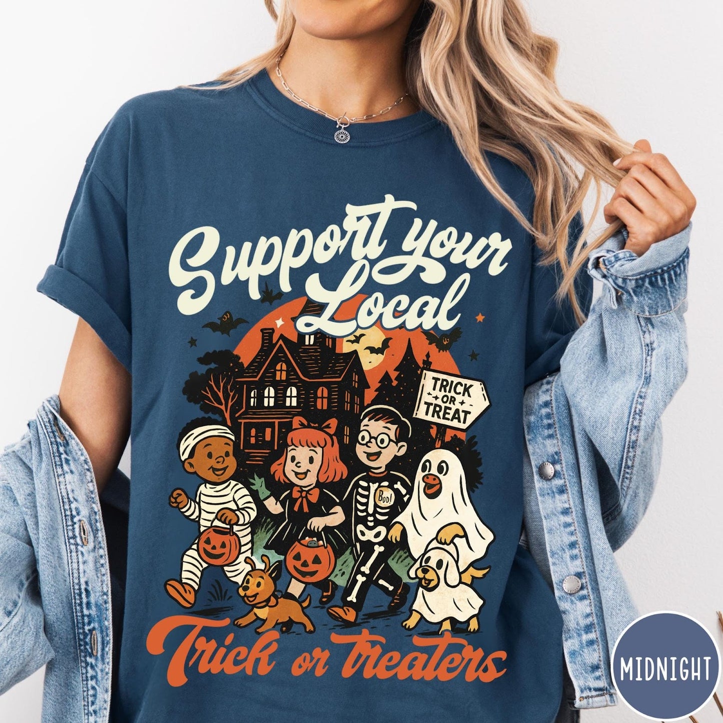 Comfort Colors tee in Midnight featuring vintage style trick or treaters graphic with a haunted house background