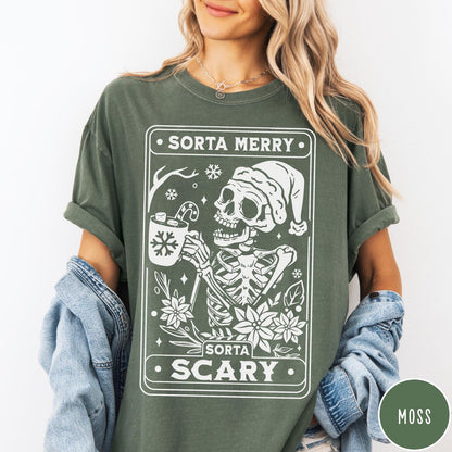 Comfort Colors tee in Moss featuring graphic illustration of a skeleton in a Santa hat holding cocoa