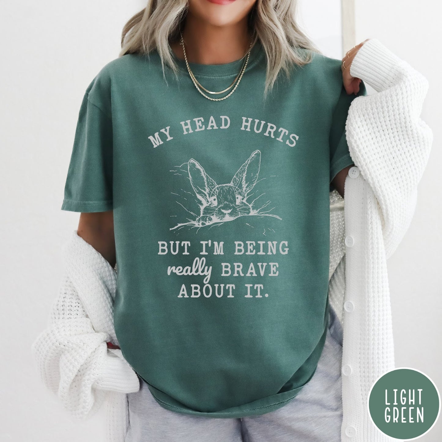 Comfort Colors tee in Light Green featuring line art graphic of a bunny resting its head on a pillow