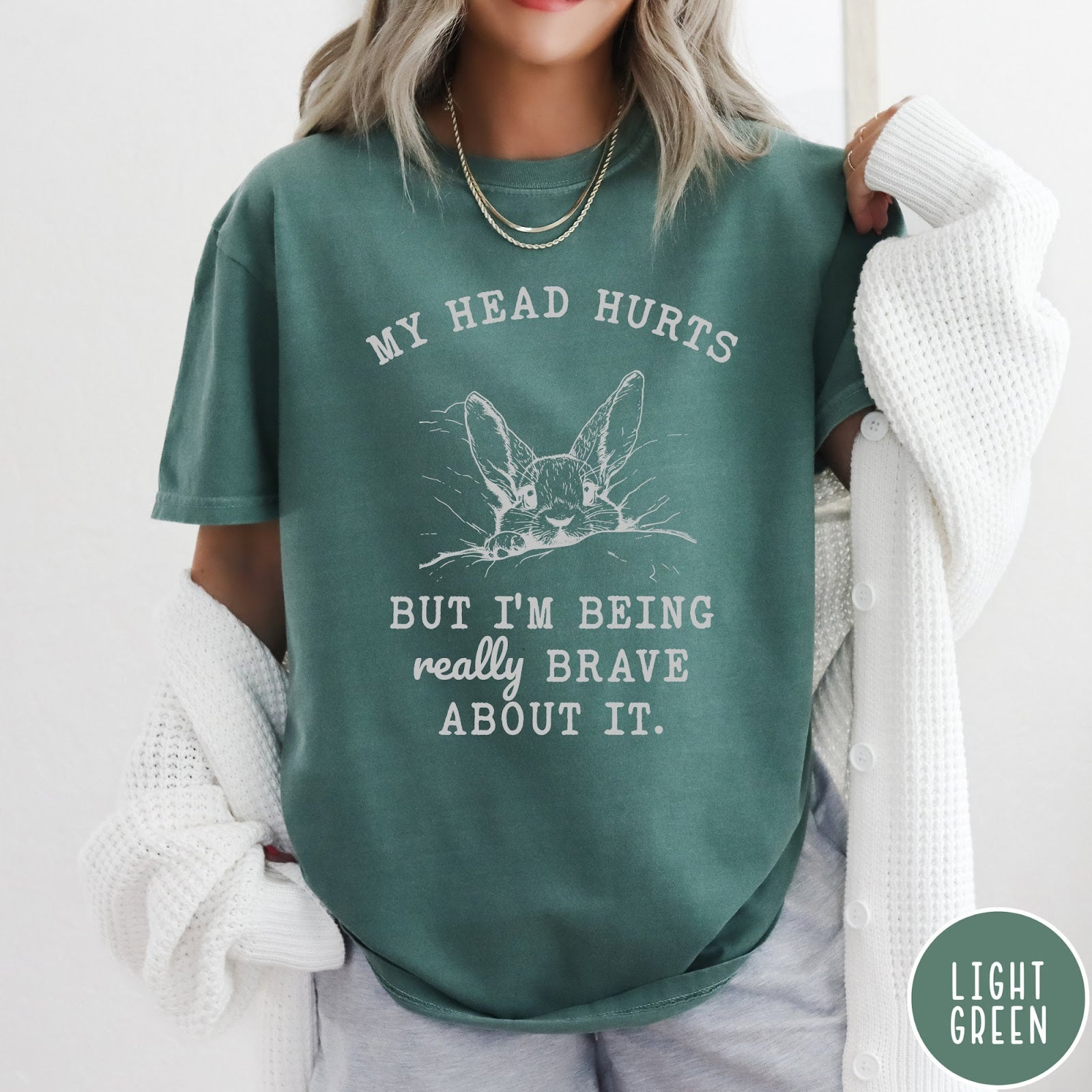 Comfort Colors tee in Light Green featuring line art graphic of a bunny resting its head on a pillow