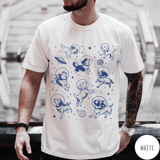 Comfort Colors tee in White featuring space theme graphic with various dogs wearing astronaut helmets and planets