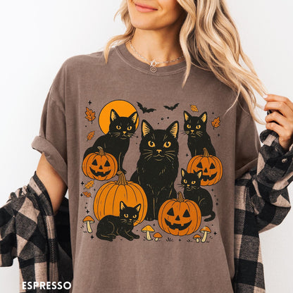 Comfort Colors tee in Espresso featuring Halloween style graphic with black cats, pumpkins, bats, and fall leaves
