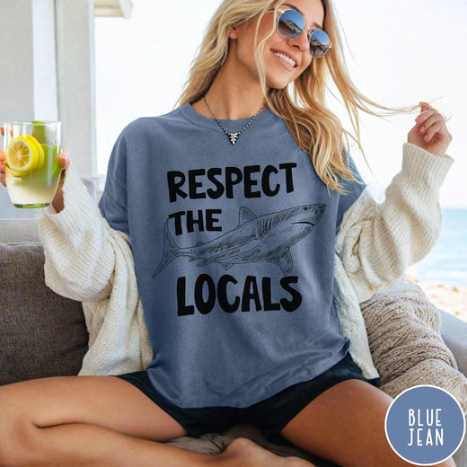 Comfort Colors tee in Blue Jean featuring sketch style shark graphic with Respect the Locals text design