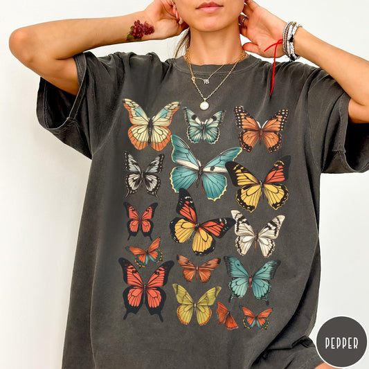 Comfort Colors tee in Pepper featuring butterfly collection design with various colorful butterfly illustrations in a grid